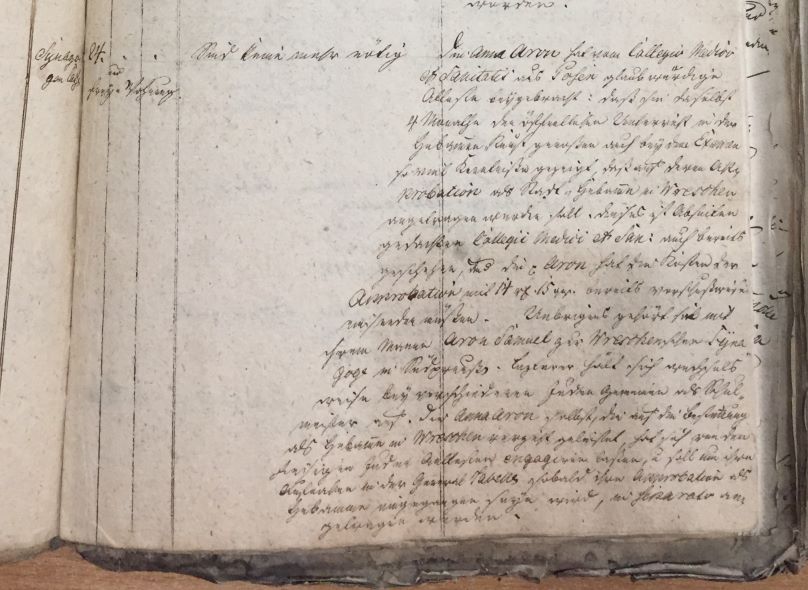 Handwritten historical document detailing the qualifications and background of a midwife named Anna Aron, including her education at Collegium Medicum et Sanitatis.